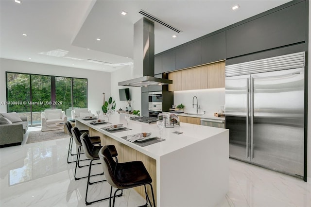 1780 Chucunantah Rd, Miami, FL 33133 - kitchen with stainless steel appliances, a sink, light marble finish floors, ventilation hood, and modern cabinets