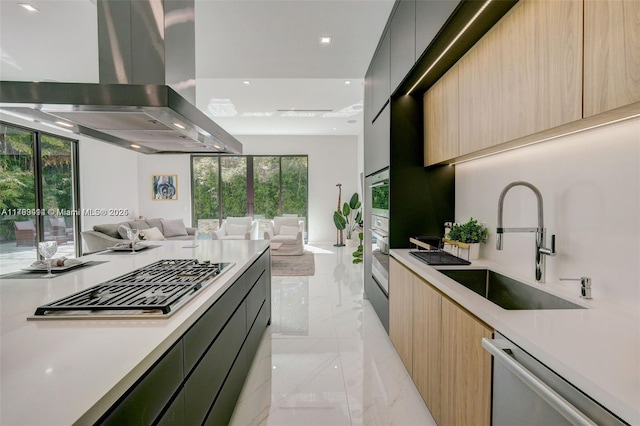 1780 Chucunantah Rd, Miami, FL 33133 - kitchen with modern cabinets, stainless steel appliances, wall chimney range hood, open floor plan, and a sink
