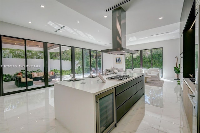 1780 Chucunantah Rd, Miami, FL 33133 - kitchen featuring island range hood, beverage cooler, open floor plan, modern cabinets, and light countertops