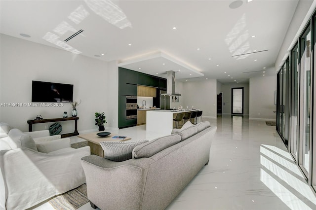 1780 Chucunantah Rd, Miami, FL 33133 - living room featuring light marble finish floors, baseboards, and recessed lighting