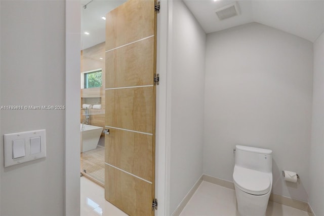 1780 Chucunantah Rd, Miami, FL 33133 - bathroom featuring toilet, baseboards, a freestanding bath, lofted ceiling, and recessed lighting