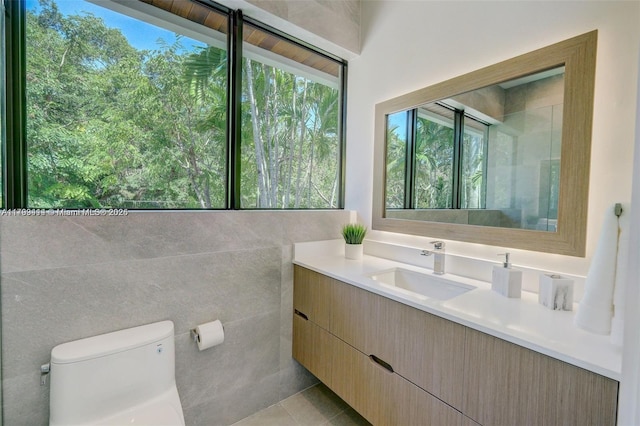 1780 Chucunantah Rd, Miami, FL 33133 - bathroom featuring toilet, tile walls, vanity, and tile patterned flooring