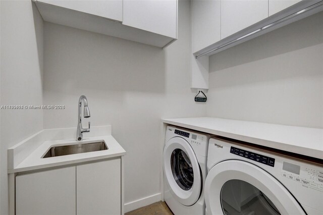 1780 Chucunantah Rd, Miami, FL 33133 - laundry area with washing machine and clothes dryer, cabinet space, and light wood finished floors