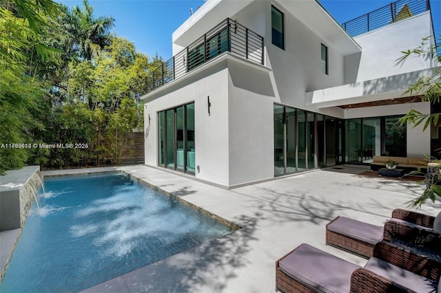 1780 Chucunantah Rd, Miami, FL 33133 - rear view of property featuring stucco siding, a patio area, a balcony, and outdoor lounge area