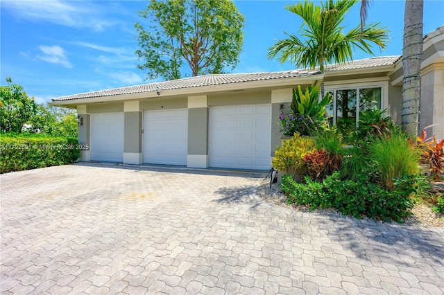 garage featuring decorative driveway