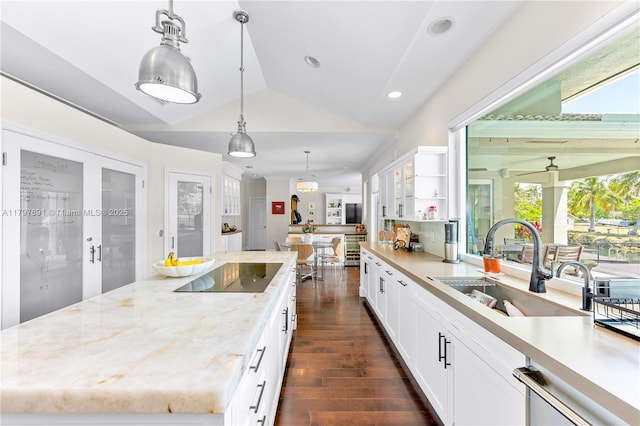 kitchen featuring black electric cooktop, a sink, dark wood-style flooring, open shelves, and vaulted ceiling