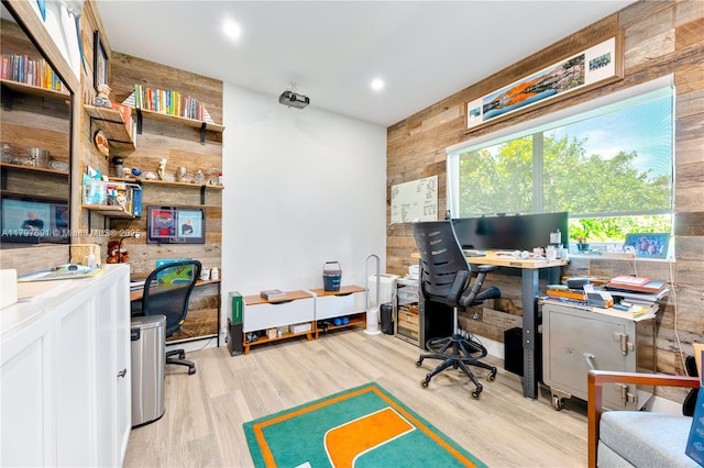 office featuring wooden walls, wood finished floors, and recessed lighting