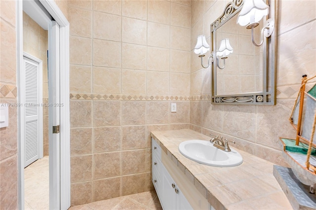 bathroom with tile walls and vanity