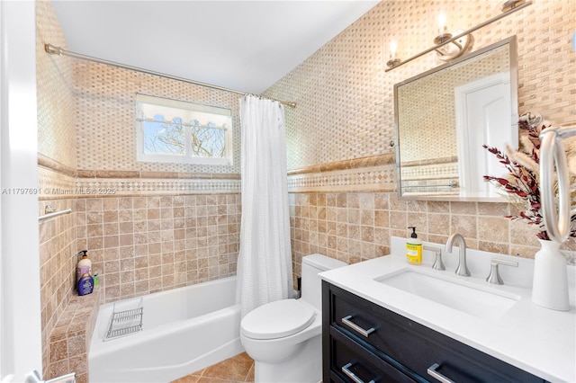 full bathroom with tile walls, toilet, vanity, shower / bath combination with curtain, and tile patterned floors