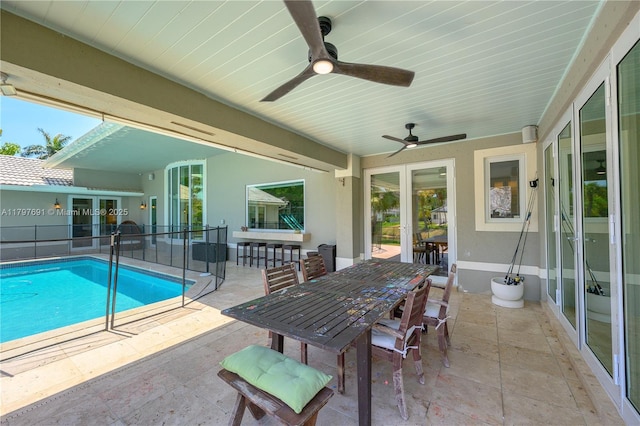view of pool with a patio, outdoor dining area, and ceiling fan