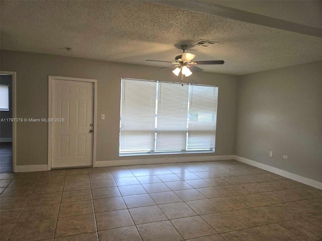 7917 Juniper St, Miramar, FL 33023 - tiled spare room with ceiling fan, baseboards, and a textured ceiling