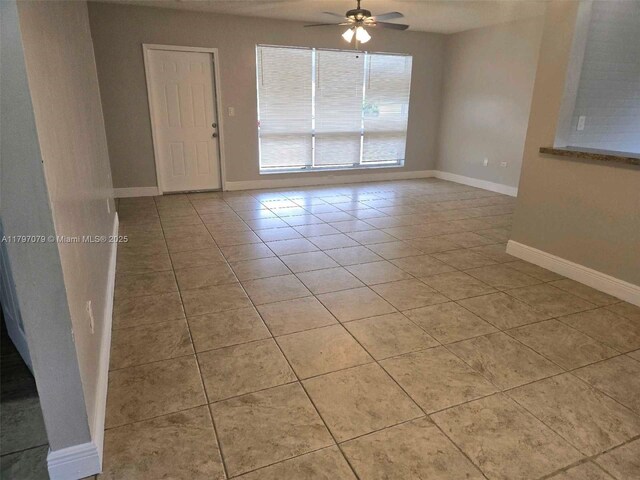 7917 Juniper St, Miramar, FL 33023 - spare room featuring a ceiling fan, light tile patterned floors, and baseboards