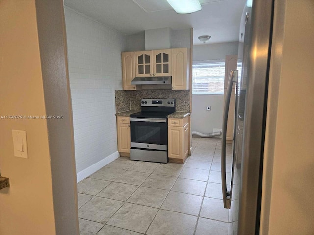 7917 Juniper St, Miramar, FL 33023 - kitchen with stainless steel appliances, under cabinet range hood, light brown cabinetry, light tile patterned flooring, and baseboards