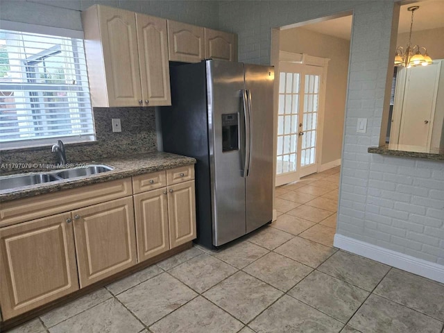 7917 Juniper St, Miramar, FL 33023 - kitchen with a sink, stainless steel fridge, baseboards, light tile patterned flooring, and a chandelier
