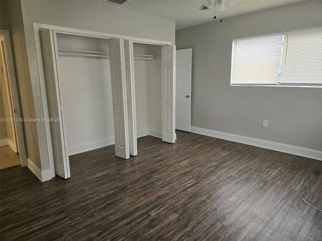 7917 Juniper St, Miramar, FL 33023 - unfurnished bedroom featuring dark wood-type flooring, baseboards, and a textured ceiling