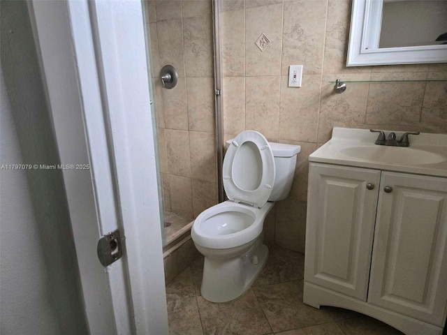 7917 Juniper St, Miramar, FL 33023 - bathroom with toilet, a shower stall, vanity, tile patterned floors, and tile walls