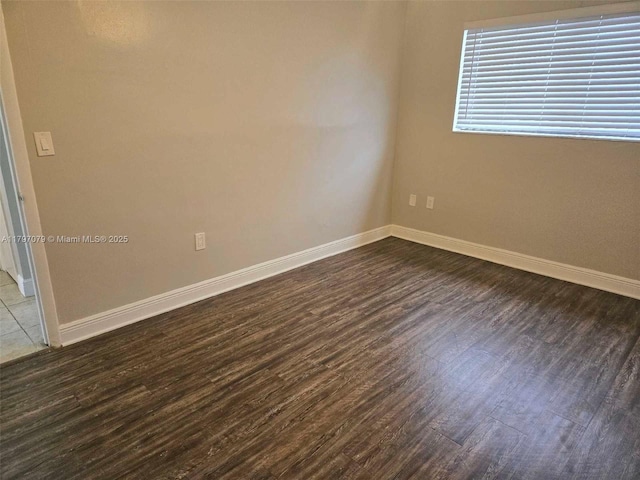 7917 Juniper St, Miramar, FL 33023 - spare room featuring dark wood-style flooring and baseboards
