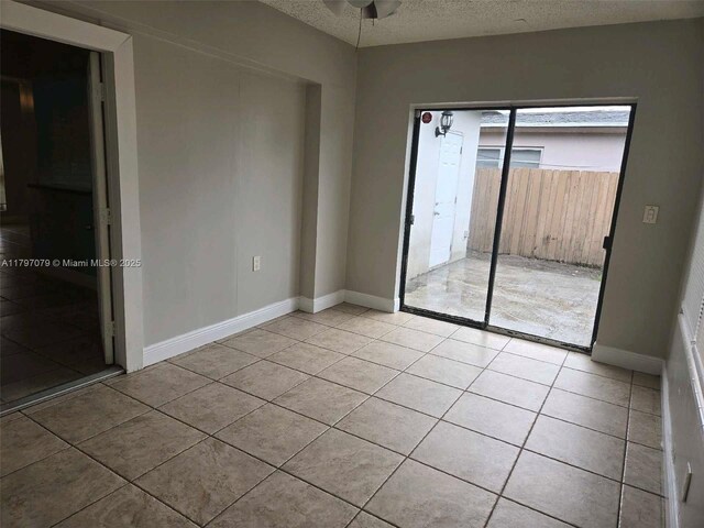 7917 Juniper St, Miramar, FL 33023 - spare room with a textured ceiling, light tile patterned floors, ceiling fan, and baseboards