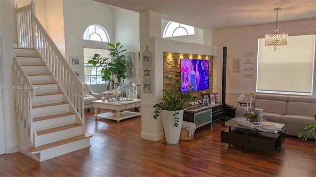 1374 NW 159th Ave, Pembroke Pines, FL 33028 - living room featuring stairs, dark wood-style flooring, a chandelier, and a towering ceiling