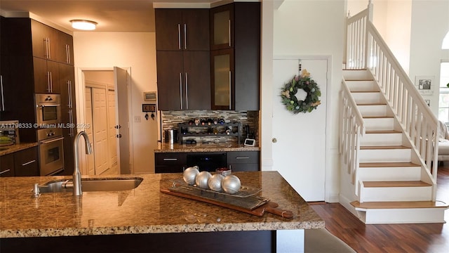 1374 NW 159th Ave, Pembroke Pines, FL 33028 - kitchen featuring a sink, dark wood finished floors, backsplash, and light stone countertops