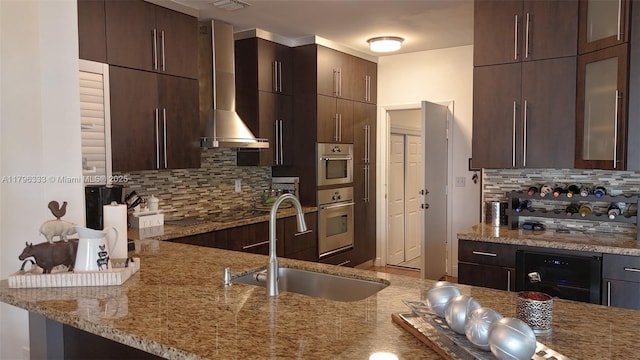 1374 NW 159th Ave, Pembroke Pines, FL 33028 - kitchen featuring wall chimney exhaust hood, a sink, tasteful backsplash, light stone counters, and stainless steel double oven