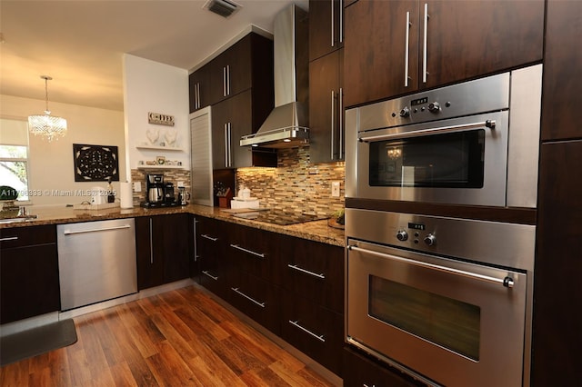 1374 NW 159th Ave, Pembroke Pines, FL 33028 - kitchen featuring appliances with stainless steel finishes, wall chimney range hood, dark wood-type flooring, backsplash, and a chandelier