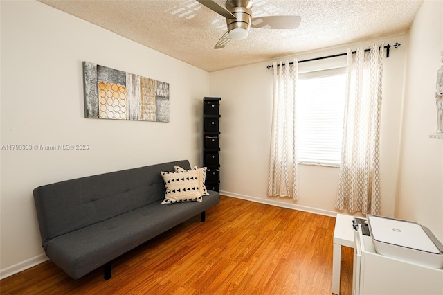1374 NW 159th Ave, Pembroke Pines, FL 33028 - sitting room featuring a textured ceiling, light wood-style floors, ceiling fan, and baseboards