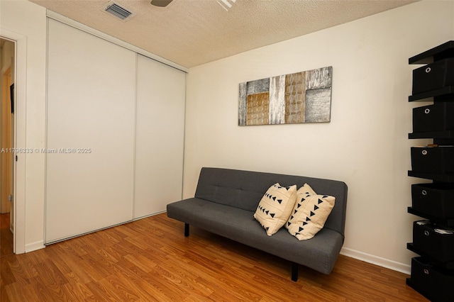 1374 NW 159th Ave, Pembroke Pines, FL 33028 - sitting room featuring wood finished floors, a textured ceiling, and baseboards