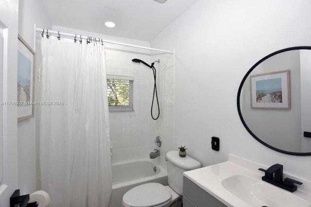 full bath featuring toilet, vanity, and shower / tub combo