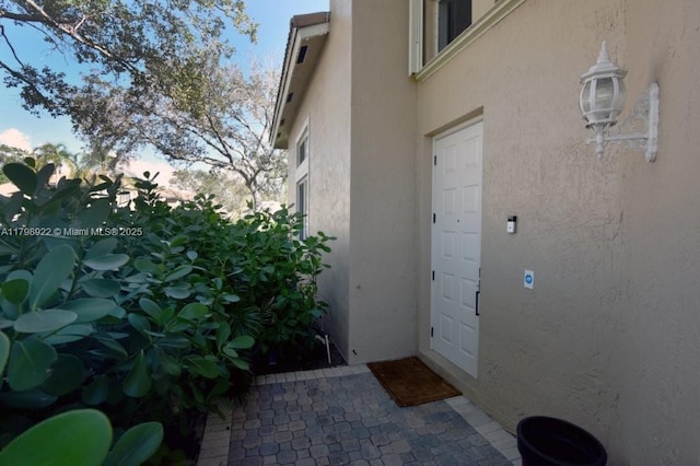 property entrance with stucco siding