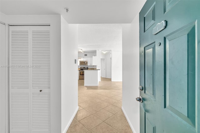 11643 W Atlantic Blvd Unit 1101, Coral Springs, FL 33071 - hallway featuring baseboards and light tile patterned floors