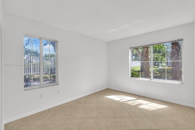 11643 W Atlantic Blvd Unit 1101, Coral Springs, FL 33071 - empty room featuring plenty of natural light, a textured ceiling, and baseboards