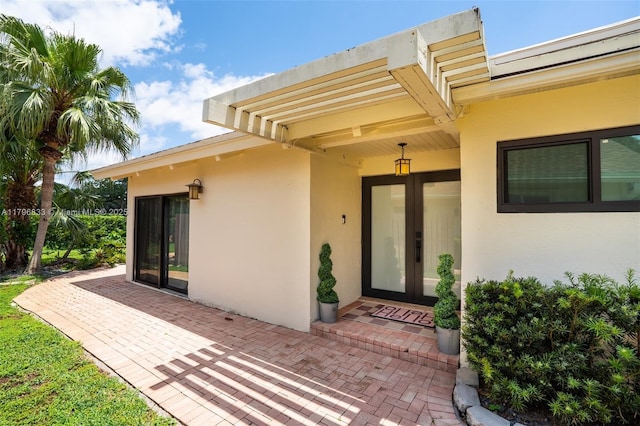 3620 E Forge Rd Unit 16, Davie, FL 33328 - view of exterior entry with stucco siding, a patio area, and french doors