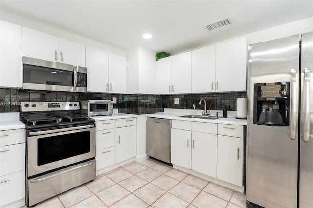 3620 E Forge Rd Unit 16, Davie, FL 33328 - kitchen with appliances with stainless steel finishes, light countertops, backsplash, white cabinetry, and recessed lighting