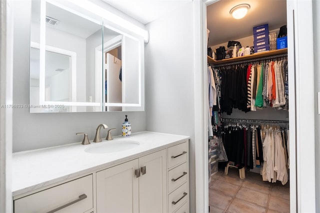 3620 E Forge Rd Unit 16, Davie, FL 33328 - bathroom featuring vanity, a spacious closet, and tile patterned flooring