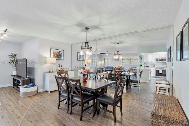 1779 NE 39th Ct Unit 1107, Pompano Beach, FL 33064 - dining room featuring wood finished floors and a textured ceiling