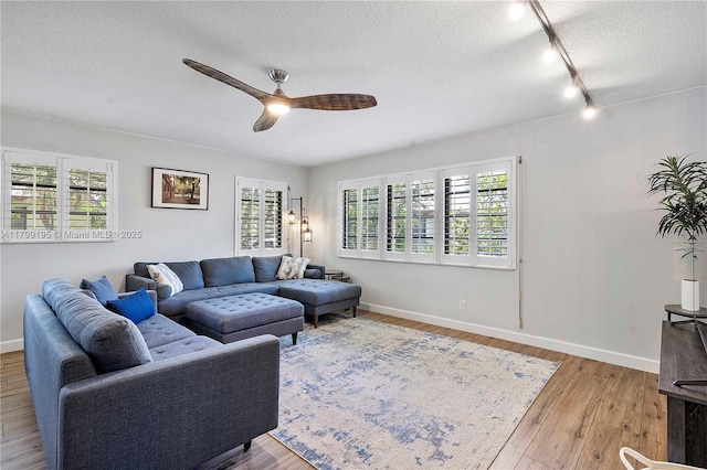1779 NE 39th Ct Unit 1107, Pompano Beach, FL 33064 - living area featuring ceiling fan, rail lighting, a textured ceiling, wood finished floors, and baseboards
