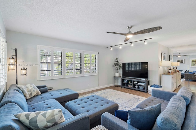 1779 NE 39th Ct Unit 1107, Pompano Beach, FL 33064 - living room with ceiling fan, track lighting, light wood finished floors, a textured ceiling, and baseboards