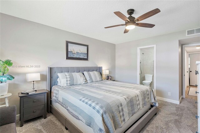 1779 NE 39th Ct Unit 1107, Pompano Beach, FL 33064 - bedroom with light colored carpet, baseboards, ensuite bathroom, ceiling fan, and a textured ceiling