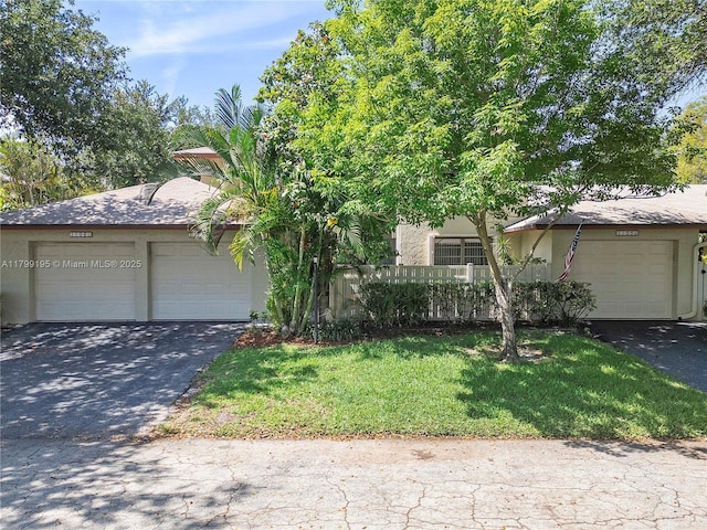 1779 NE 39th Ct Unit 1107, Pompano Beach, FL 33064 - view of front of property with stucco siding, a front lawn, driveway, and a garage