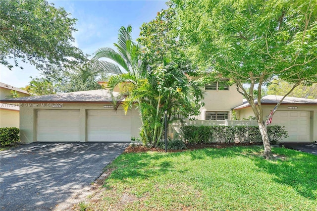 1779 NE 39th Ct Unit 1107, Pompano Beach, FL 33064 - view of front of home featuring stucco siding, a garage, and a front yard