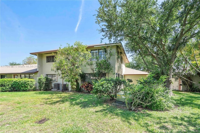 1779 NE 39th Ct Unit 1107, Pompano Beach, FL 33064 - back of house featuring stucco siding, central AC unit, and a yard
