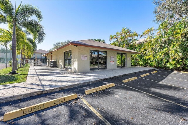 1779 NE 39th Ct Unit 1107, Pompano Beach, FL 33064 - back of house with stucco siding and uncovered parking