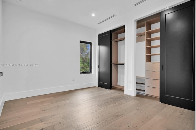30 NE 50th St, Miami, FL 33137 - unfurnished bedroom featuring light wood-style floors, baseboards, and recessed lighting