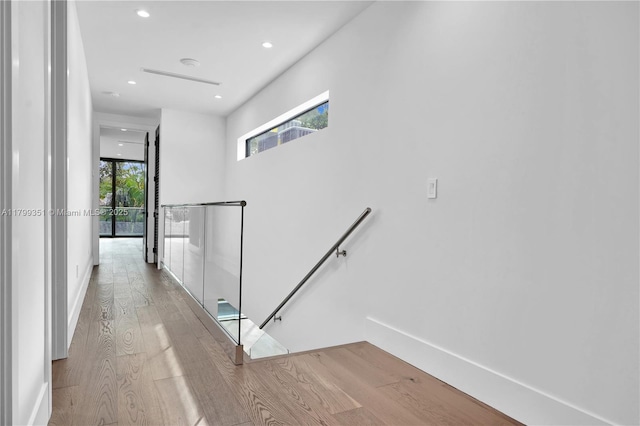 30 NE 50th St, Miami, FL 33137 - hallway with an upstairs landing, wood finished floors, recessed lighting, and baseboards