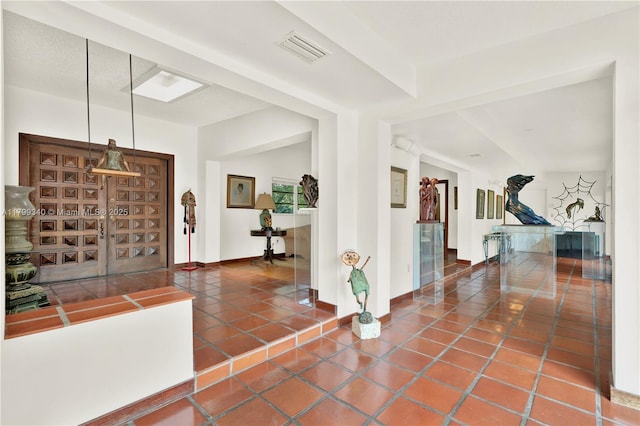tiled foyer featuring baseboards
