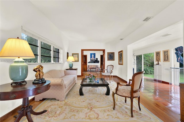 living area featuring baseboards and wood finished floors