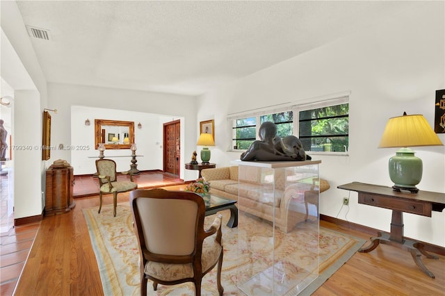 living area with wood finished floors and baseboards
