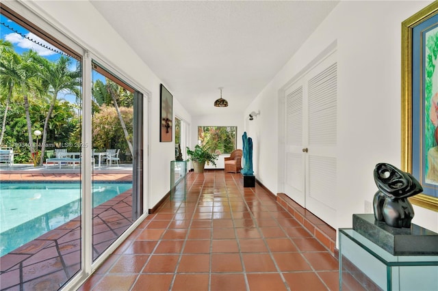 hall with tile patterned flooring and baseboards