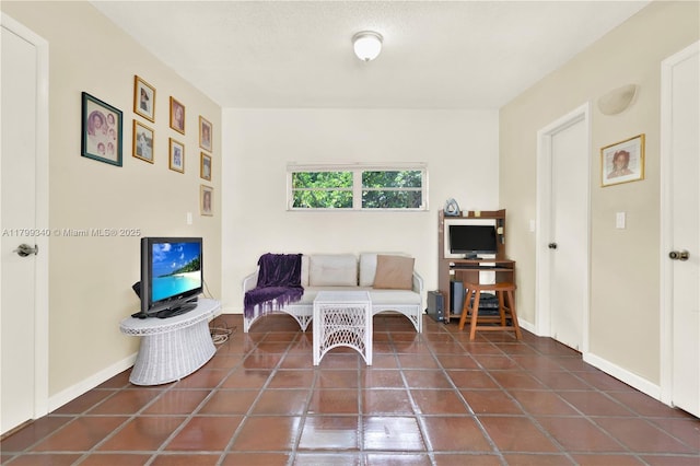 sitting room featuring tile patterned floors and baseboards